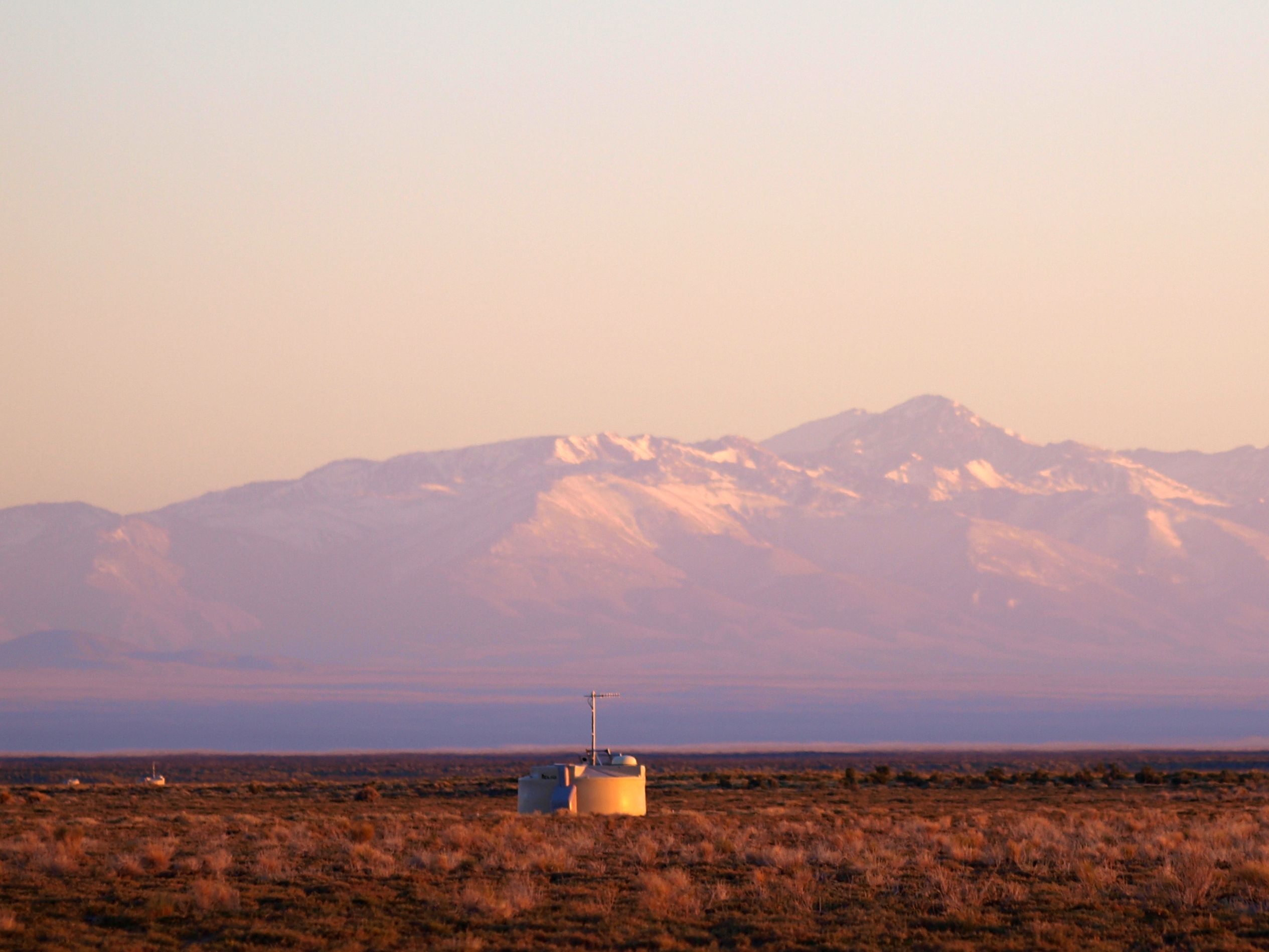 Three of the stations of the Surface Detectors in the Pierre Auger Observatory in a row towards the Andes, at sunrise. Image credit: Lorenzo Caccianiga
